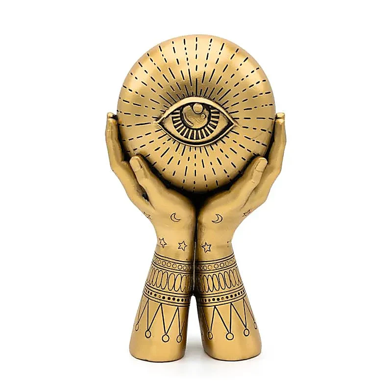 altseende øje statue i guldfarve